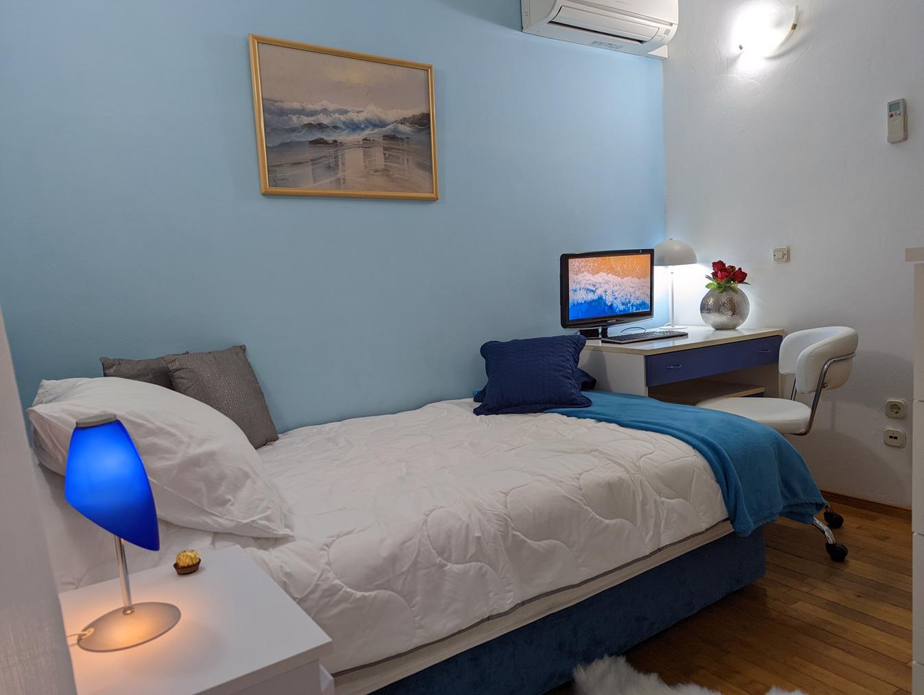 Bedroom 4, air-conditioned, smart TV, minibar, en suite bathroom, garden view.